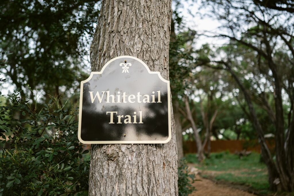 sign for the messina inn walking path called "Whitetail Trail" 